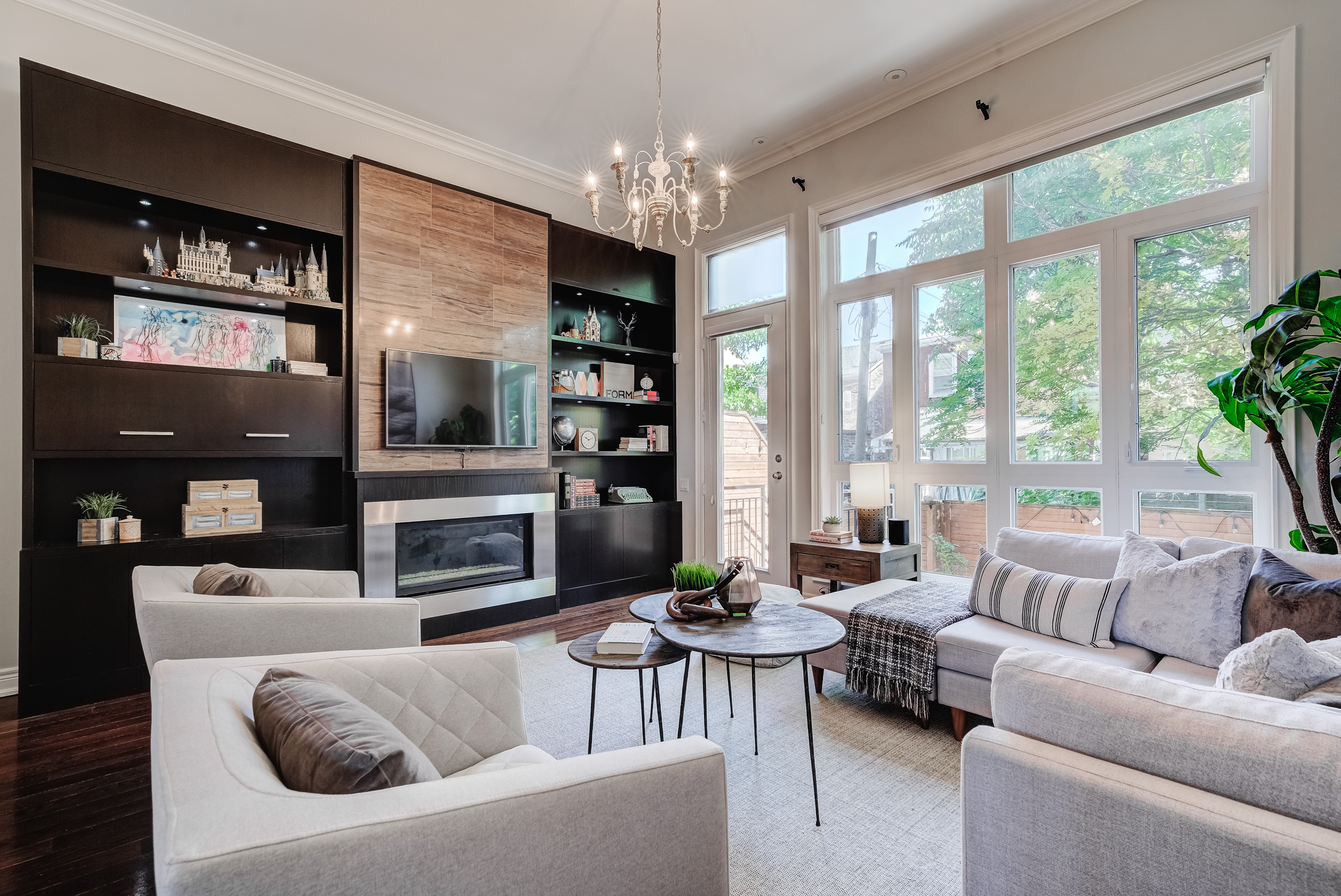 Living room with wall of windows facing out to the back yard patio.